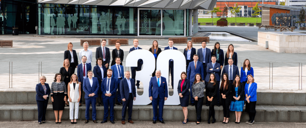 FPM team standing with 30 sign celebrating 30 years
