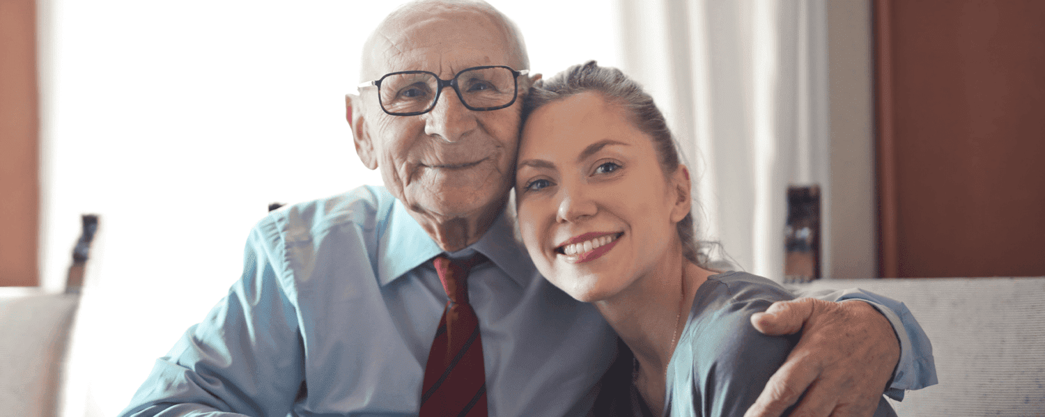 Older man and younger woman sat together.