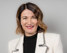 An image of Gillian Forrest wearing a white blazer with a black top.