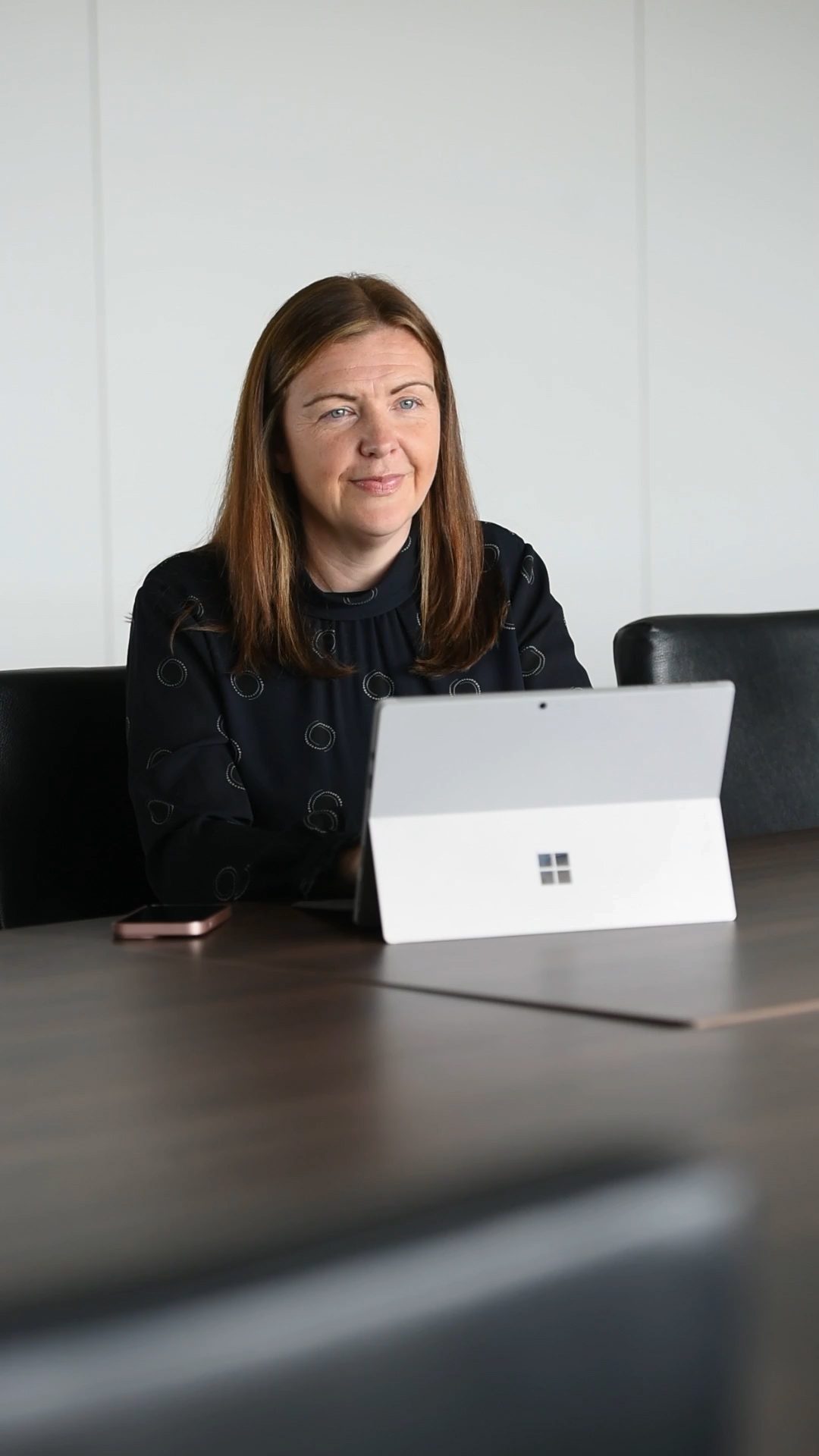 An image of Nicola MacLennan sitting at a desk with a laptop in front of her.