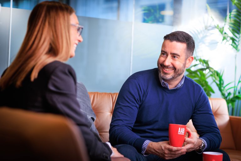AAB staff members chatting over cup of coffee.