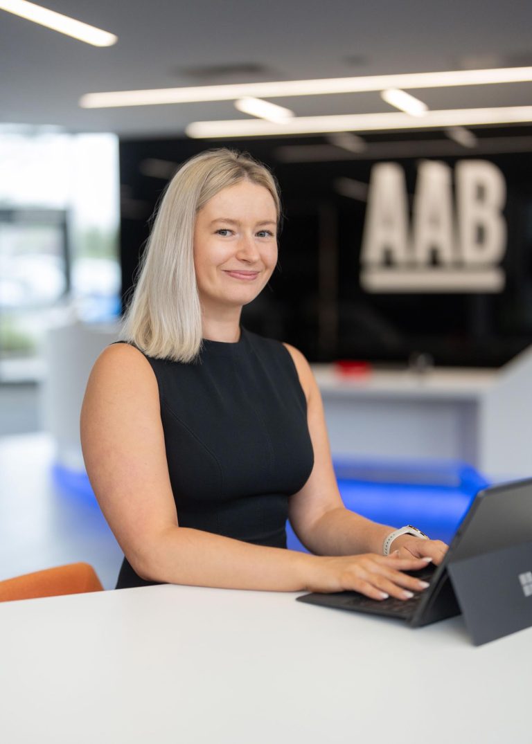 Claire Marston working on laptop in AAB office.