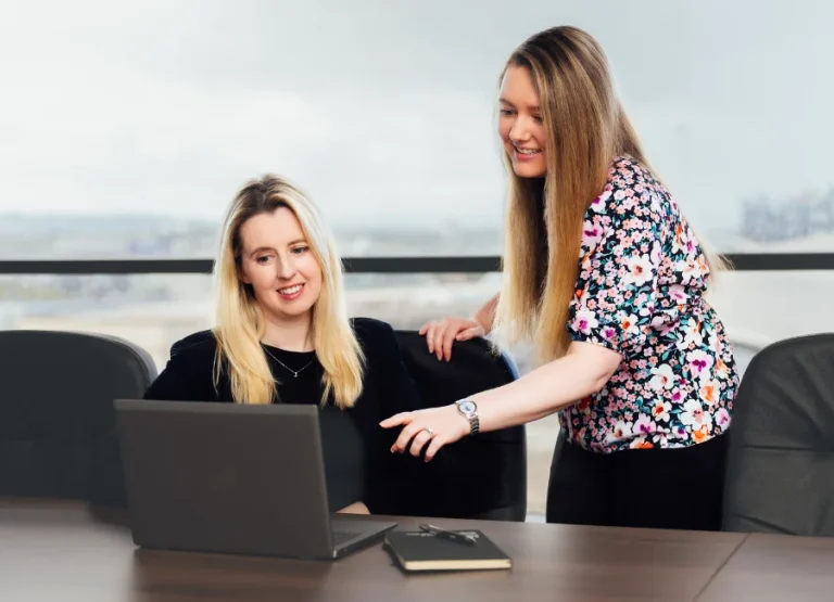 AAB team members looking at laptop on a desk.