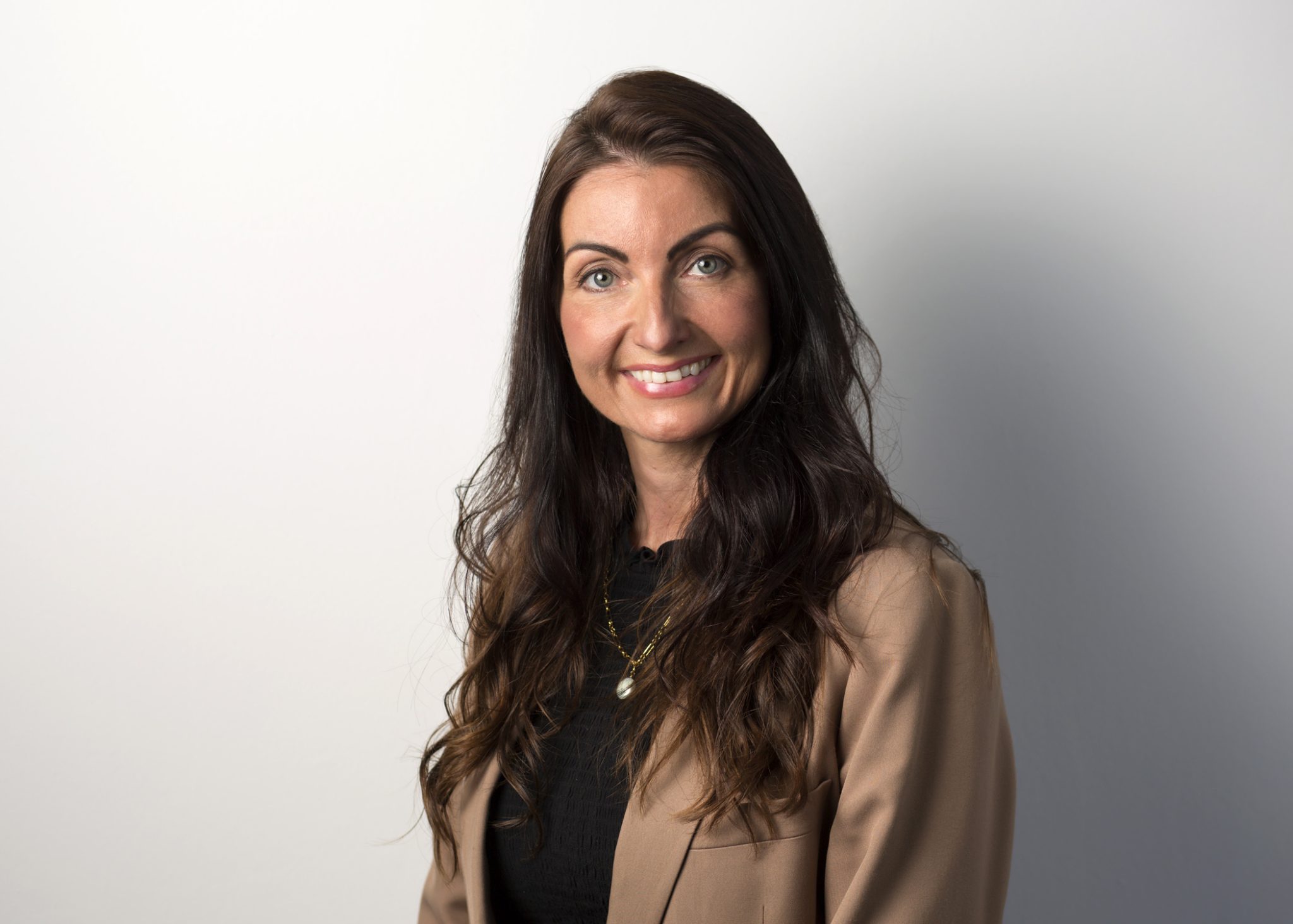 An image of Helen Learmonth wearing a brown blazer with brown hair.