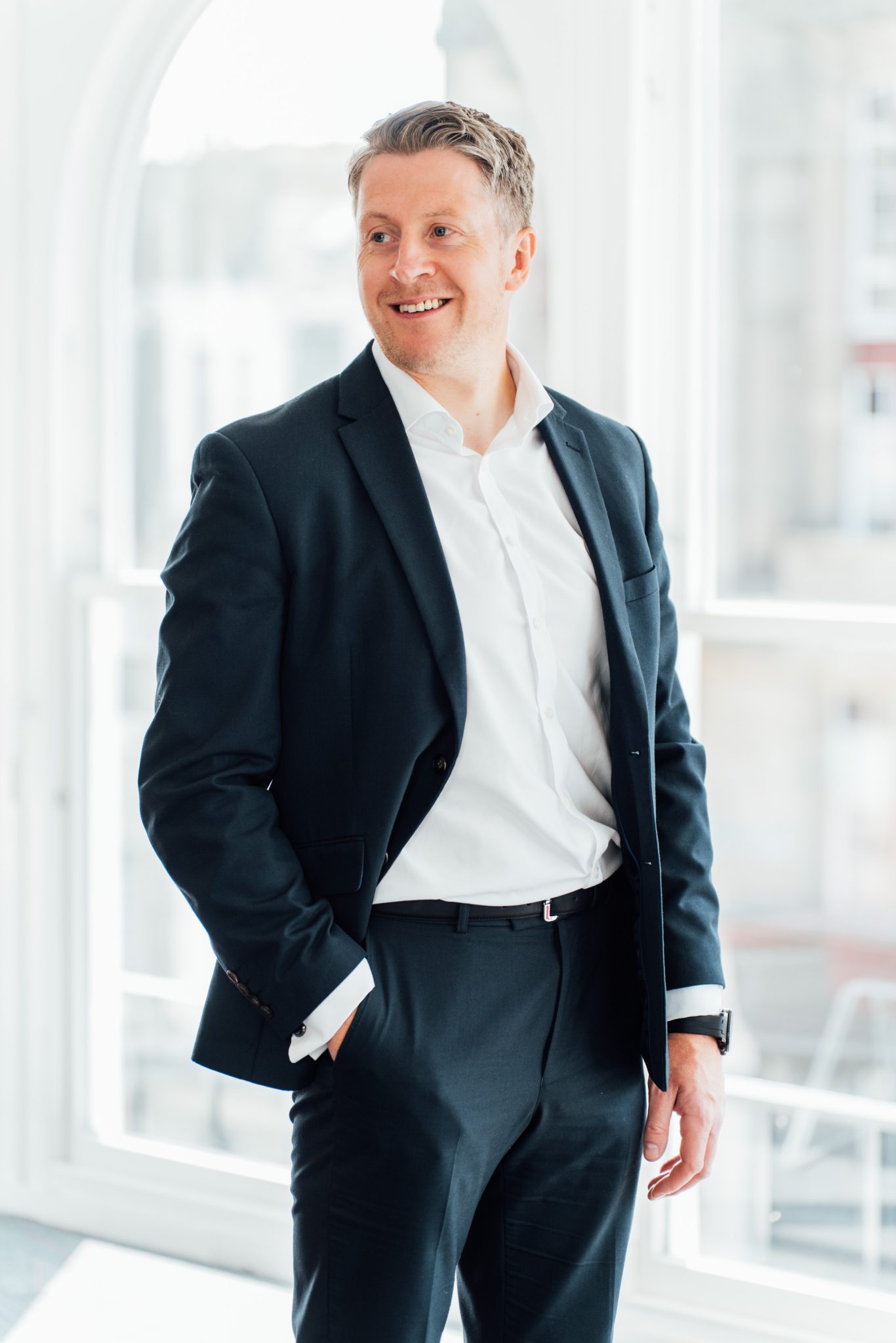 An image of Paul Turner standing in the Edinburgh office with his hand in his pocket.
