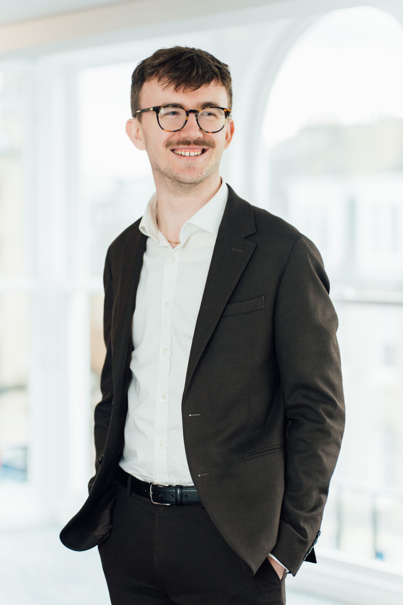 An image of Andrew Philbin wearing a blazer and shirt whilst smiling at the camera.