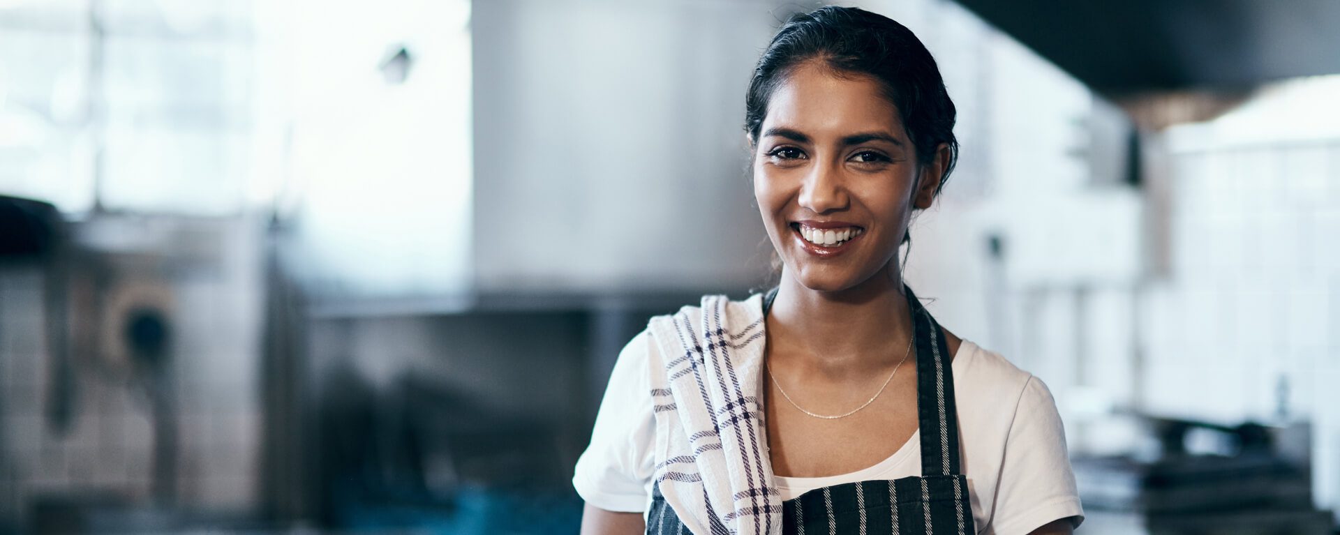 VAT Advice banner showing a woman in a kitchen wearing an apron and a dishcloth over her shoulder.