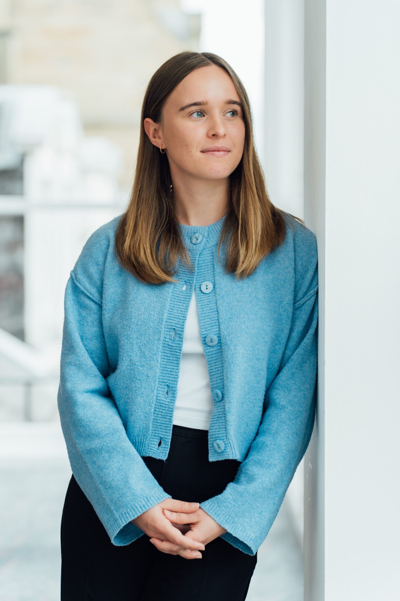 An image of Louise Neilson standing and looking our a window.