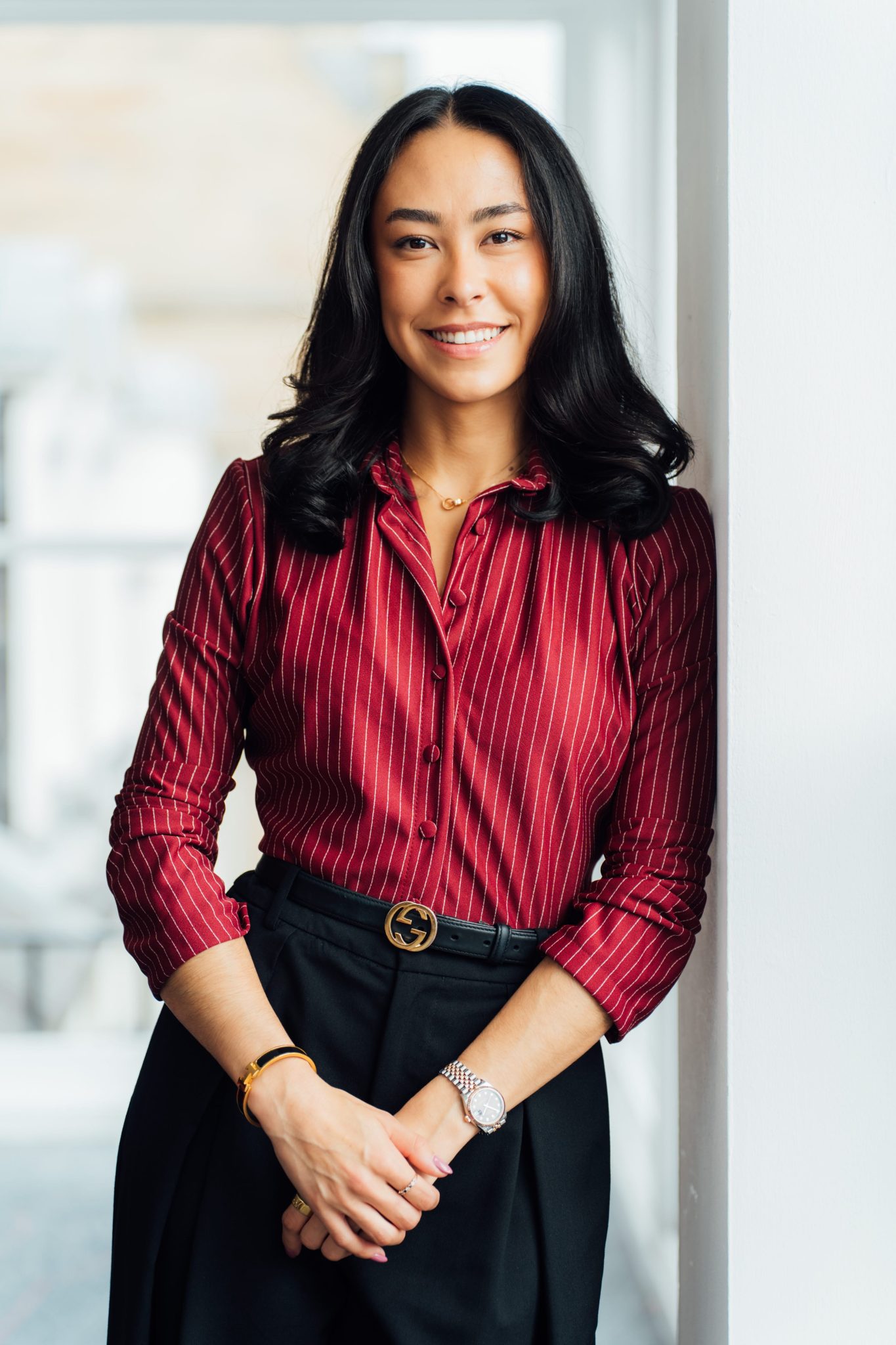 An image of Hannah Wildsmith wearing a black skirt with burgandy top.