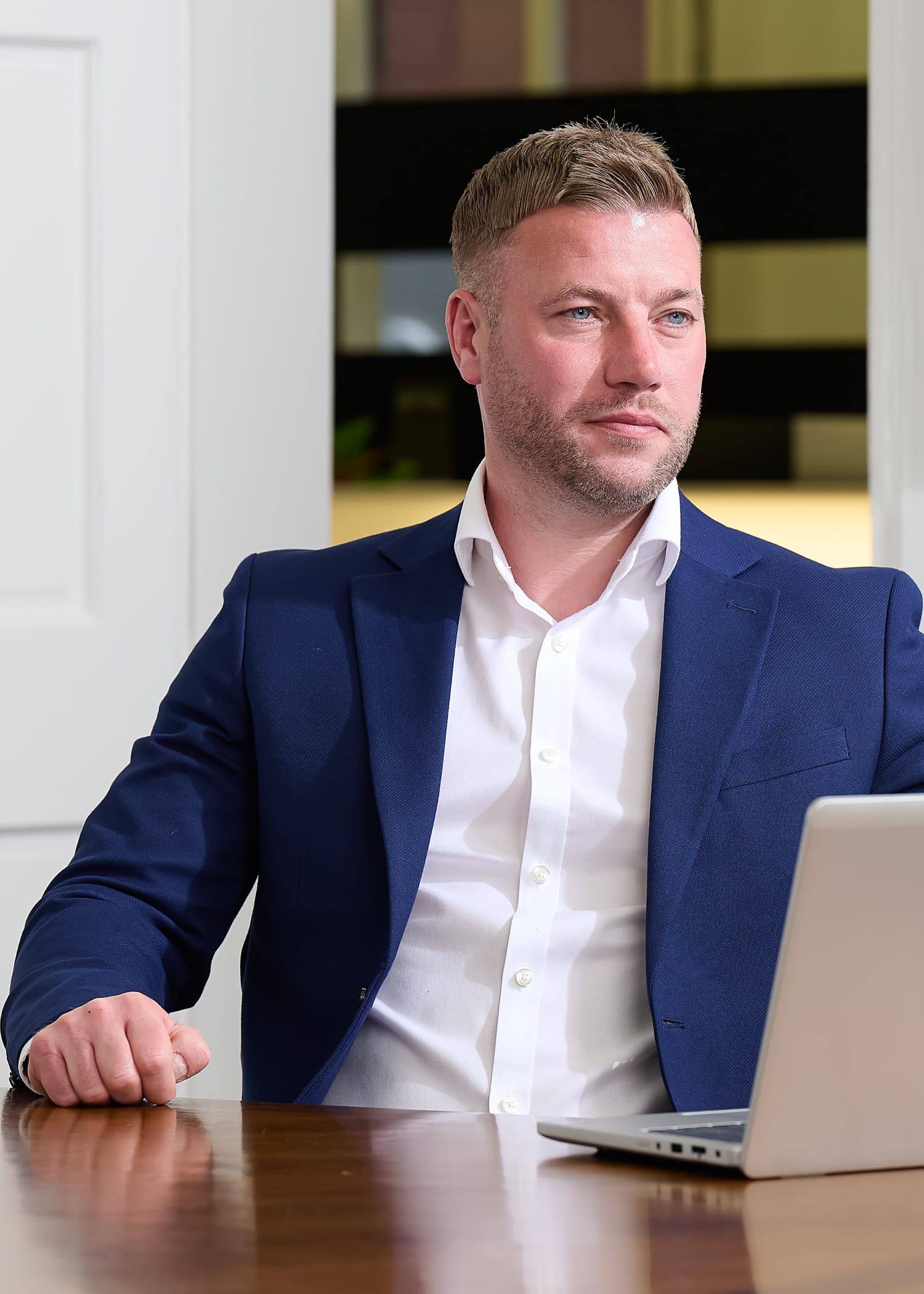 An image of Chris Cook-Martin sitting at his desk with his laptop.
