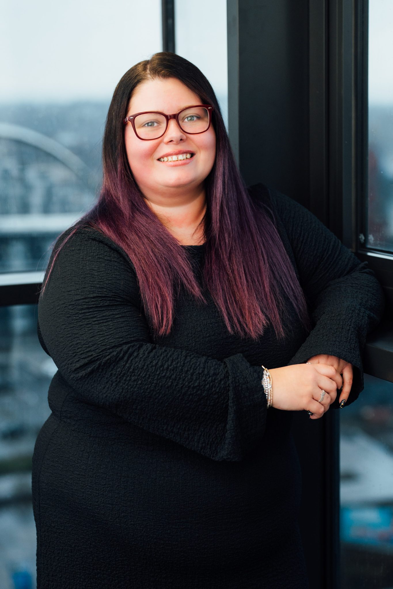An image of Danielle McInroy wearing black top and smiling at the camera.