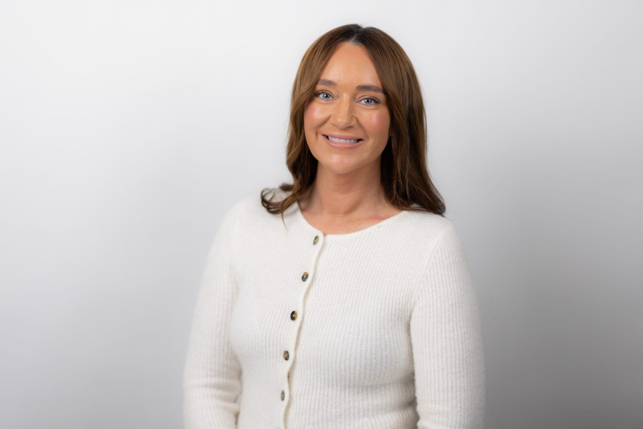 An image of Donna Blackburn wearing a white top and smiling at the camera.